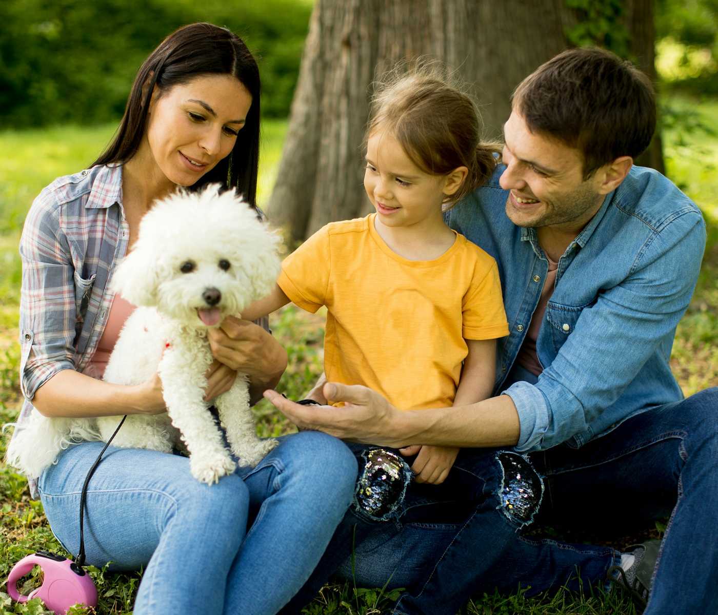 family with dog in park